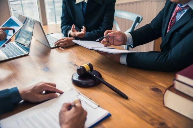 Law_professionals_engaged_in_a_discussion-with_laptops_and_legal_documents_on_a_wooden_table_symbolizing_a-blend-of_traditional_and_modern_legal_practice